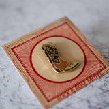 Brown Cowboy Boot Enamel Pin in Packaging Close Up View