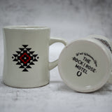 The Red Out Yonder Mug Next To The Bottom Of The Brown Out Yonder Mug